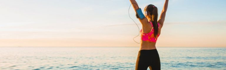 woman stretching on beach